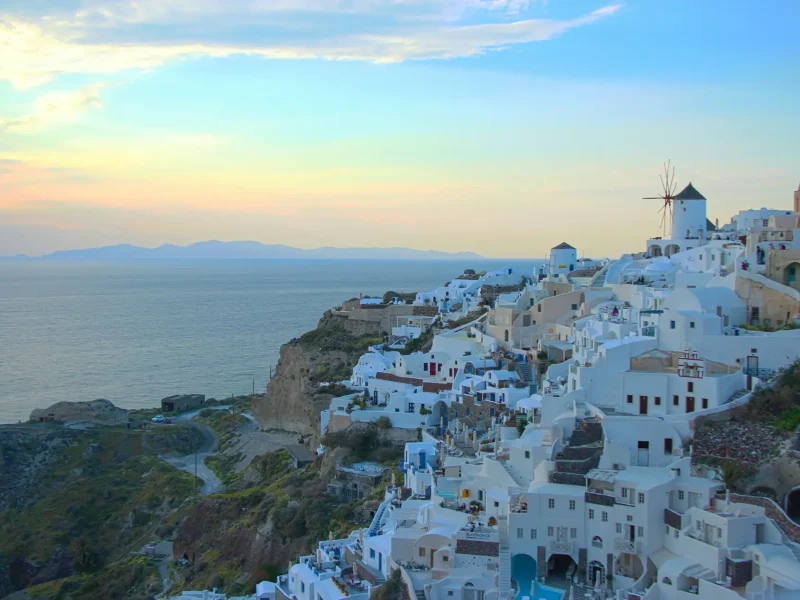 Oia village Santorini at sunset with blue domes — Mediterranean cruise port experience