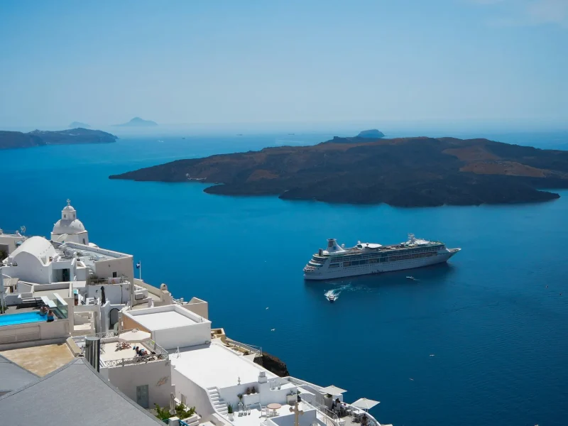 Santorini caldera with cruise ship anchored at sunset — Mediterranean cruise ports for Indian travellers